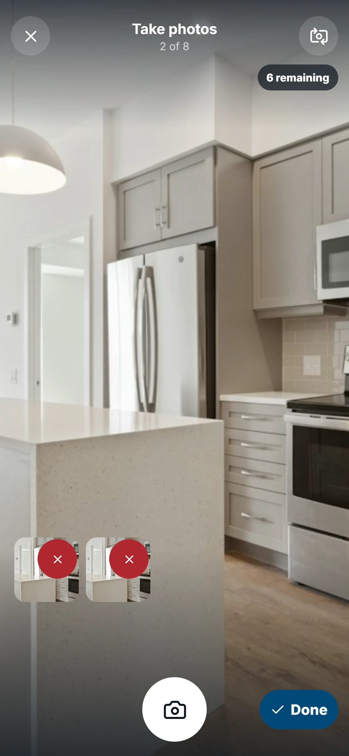 Mobile camera demo with an illustrative kitchen preview, two captured photos, six remaining slots, and the Done button.